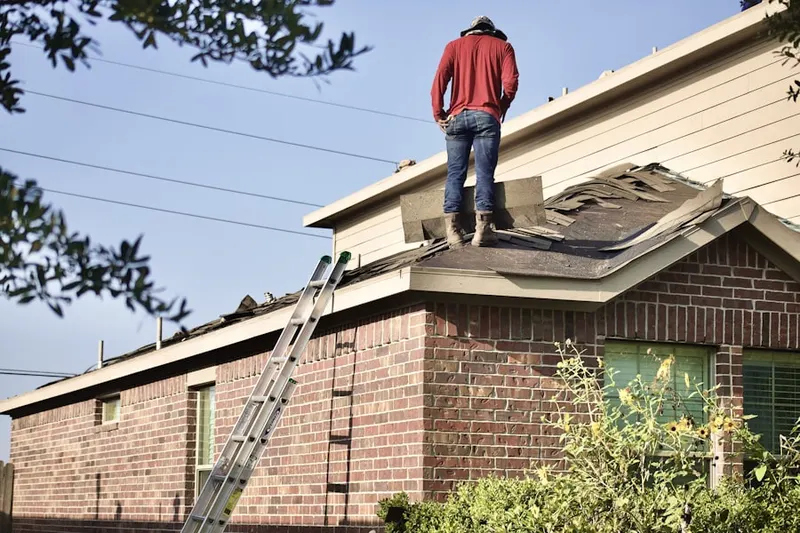 Professional roofer working on a residential roof in Luciusboro